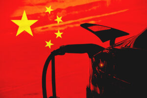Electric vehicle with Chinese flag stars on a red background symbolising the rise of Chinese car brands in Europe.