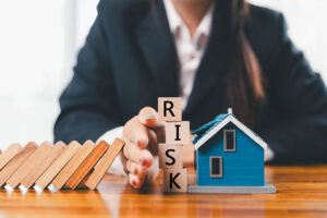 Falling dominoes illustrating how a property chain collapse can cause multiple UK house sales to fall through.